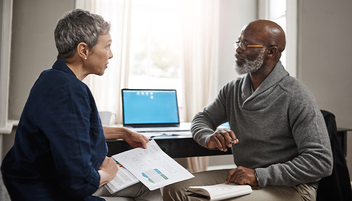 senior couple sitting down to discuss finances and budeting for retirement will you have enough to retire