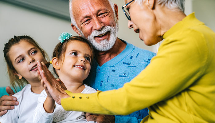 smiling grandparents with their granddaughters will you have enough to retire